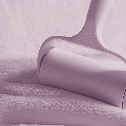 Close-up of a purple textured fabric with a hanger on a matching background